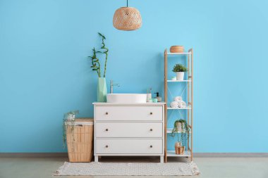 Interior of bathroom with sink, drawers and shelving unit