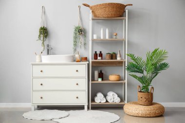 Interior of bathroom with sink, drawers and shelving unit