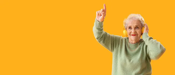 Senior Woman Headphones Listening Music Yellow Background Space Text — Stock Photo, Image