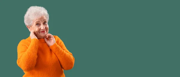 Senior Woman Orange Sweater Green Background Space Text — Stock Photo, Image