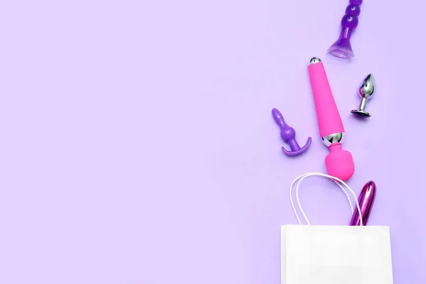 stock image Shopping bag with sex toys on lilac background