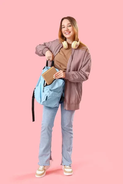 Female Student Putting Book Backpack Pink Background — Stock Photo, Image