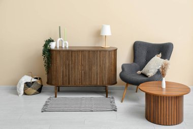 Çekmeceleri, koltuğu, masası ve yumuşak halısı olan şık bir oturma odası.