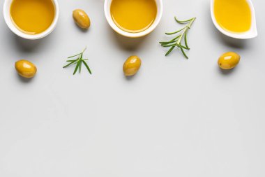 Gri arka planda taze zeytinyağlı kaseler