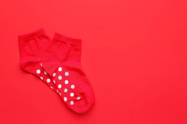 stock image Pair of cotton socks on red background