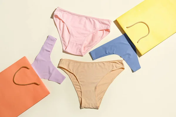 Set Stylish Female Panties Paper Bags Light Background — Stock Photo, Image