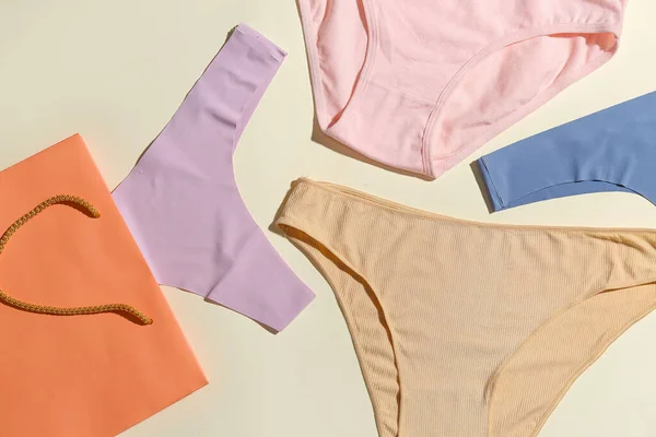 Set Stylish Female Panties Paper Bag Light Background Closeup — Stock Photo, Image