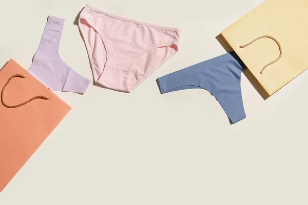 Set Stylish Female Panties Paper Bags Light Background — Stock Photo, Image