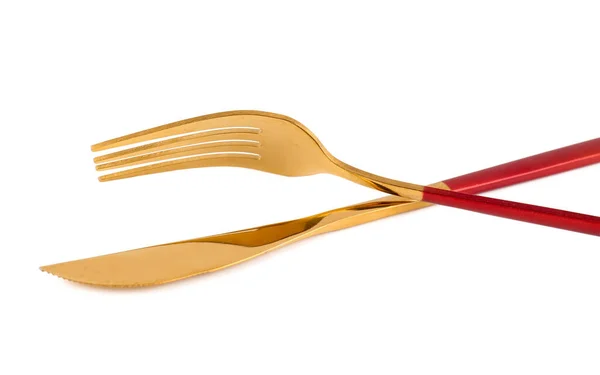 白い背景に赤いハンドルを持つ黄金のフォークとナイフ — ストック写真