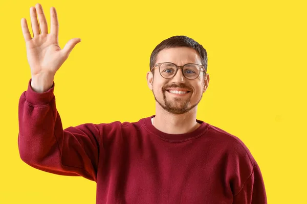 Handsome Man Stylish Eyeglasses Waving Hand Yellow Background — Stock Photo, Image