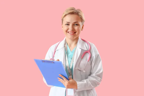 Female Medical Intern Clipboard Pink Background — стоковое фото