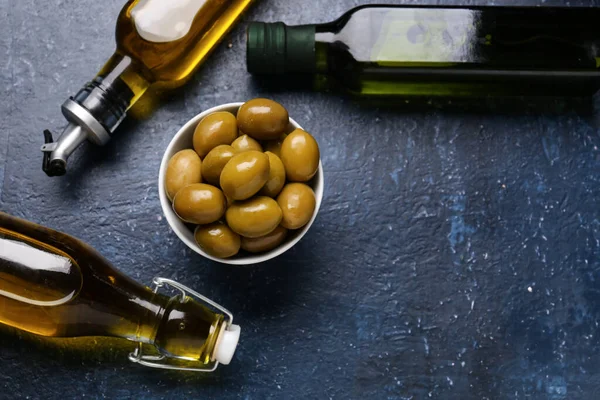 Bowl Ripe Olives Bottles Oil Blue Background — Stock Photo, Image