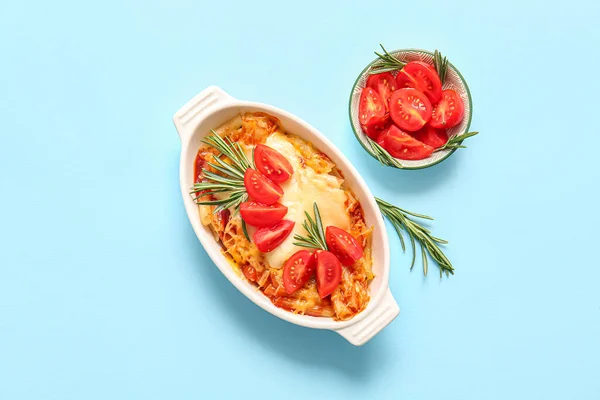 stock image Baking dish of pasta with tomato sauce and cheese on blue background