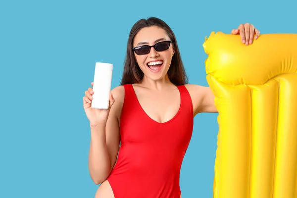 Young Woman Sunscreen Cream Inflatable Mattress Blue Background — Stock Photo, Image