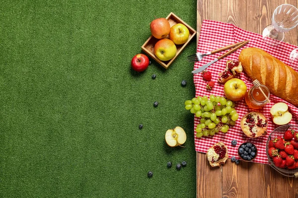 stock image Composition with tasty food for picnic and glasses on wooden table outside