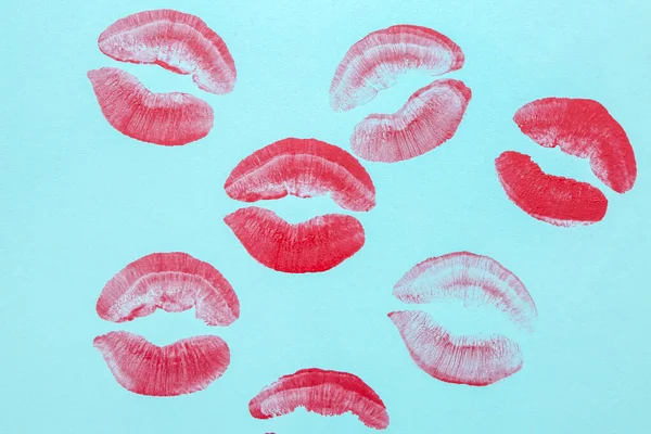 Red lipstick kiss marks on blue background