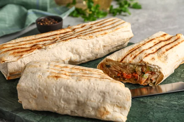 stock image Board of tasty shawarma on grey table, closeup