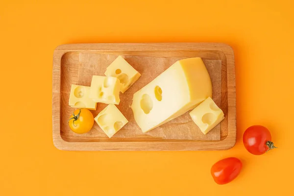 Board Pieces Swiss Cheese Tomatoes Orange Background — Stock Photo, Image