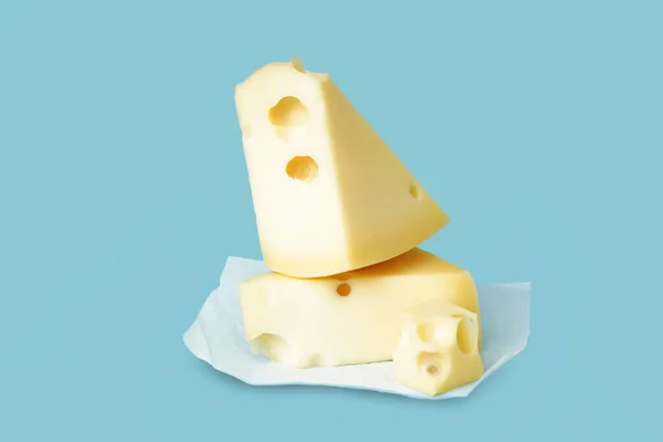 Baking Paper Pieces Swiss Cheese Blue Background — Stock Photo, Image
