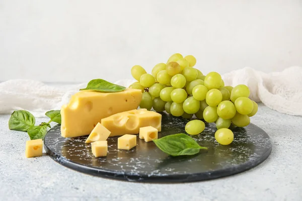 Board Tasty Swiss Cheese Grapes Light Background — Stock Photo, Image