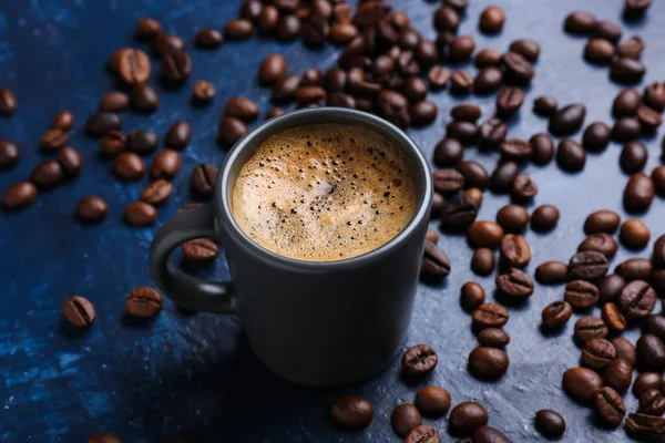 蓝色背景的热浓缩咖啡和咖啡豆杯 — 图库照片
