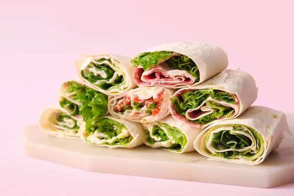 Board Tasty Lavash Rolls Sausages Greens Pink Background — Stock Photo, Image