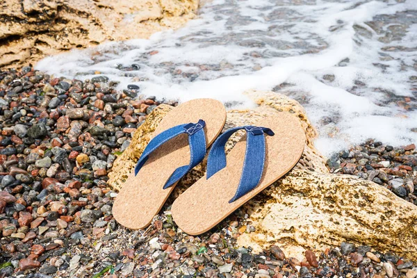 stock image Stylish flip-flops on sea shore