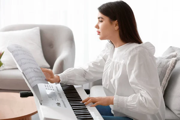 年轻的女音乐家在家里演奏合成器 — 图库照片