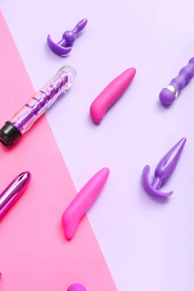 stock image Vibrators with anal plugs on color background