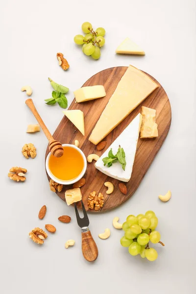 Wooden Board Different Types Tasty Cheese Grapes Honey Grey Background — Stock Photo, Image
