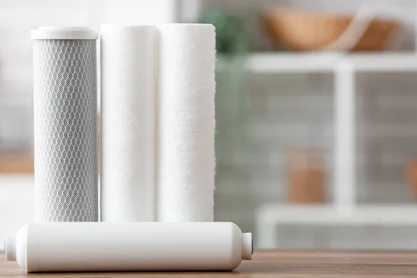 stock image Water filters on wooden table in kitchen