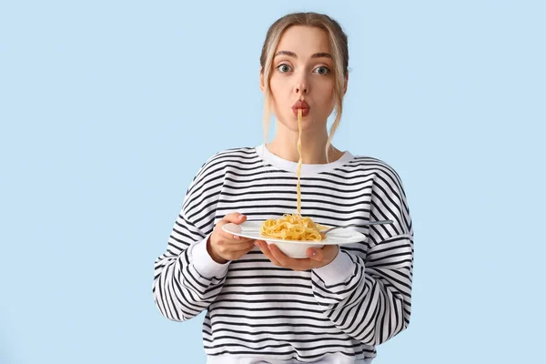 Young Woman Eating Tasty Pasta Blue Background — Stock Photo, Image
