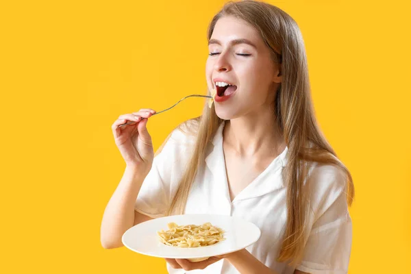 Young Woman Eating Tasty Pasta Yellow Background — Stock Photo, Image