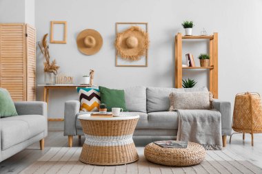 Oturma odasının içinde raflar, masa ve kanepeler var.