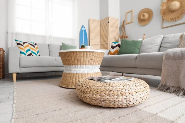 stock image Interior of light living room with surfboard, table and sofas