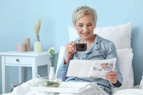Mature Woman Cup Coffee Reading Newspaper Bedroom — Stock Photo, Image