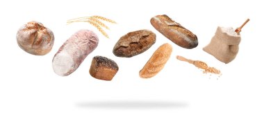 Uçan taze ekmek, dikenler, tohumlar ve un beyaz arka planda