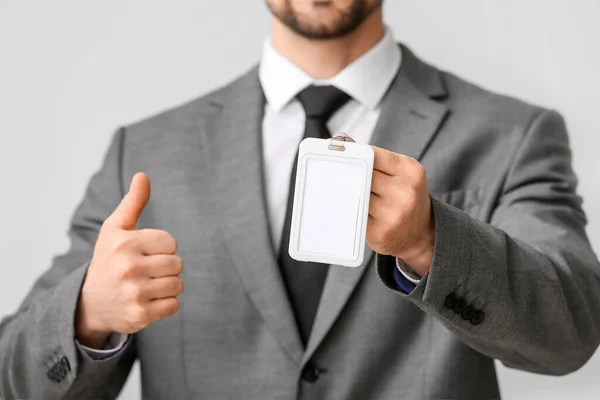Young Businessman Blank Badge Showing Thumb Light Background Closeup — Stock Photo, Image