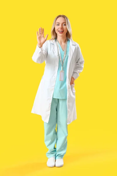 Žena Lékař Mává Rukou Žlutém Pozadí — Stock fotografie