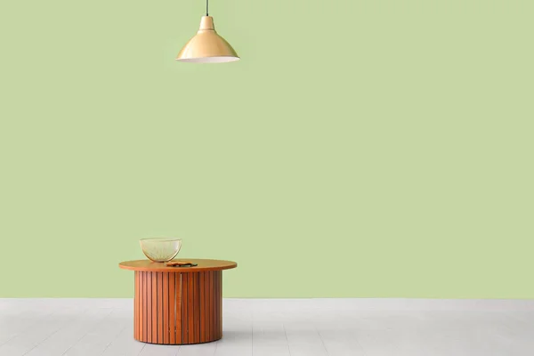 緑の壁の近くに金属製のボウル木製のコーヒーテーブル — ストック写真