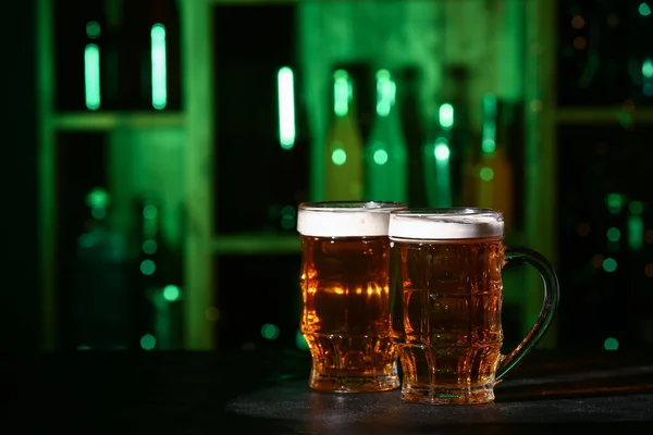 stock image Mugs of fresh beer on table in bar