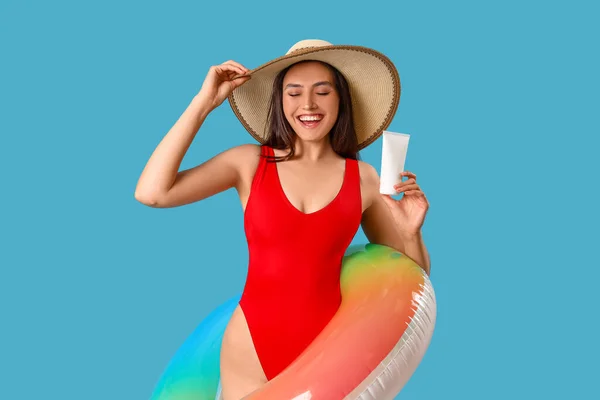 Young Woman Sunscreen Cream Inflatable Ring Blue Background — Stock Photo, Image