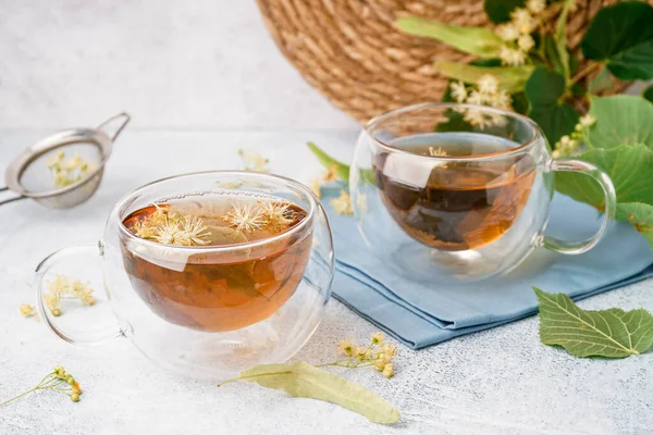 stock image Glass cup of linden tea on white background