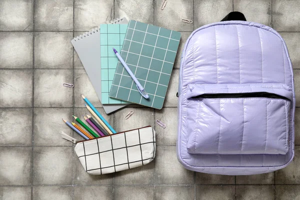 Lilac School Backpack Notebooks Pencil Case Paper Clips Grey Tile — Stock Photo, Image