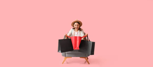 Happy Young Woman Shopping Bags Sitting Armchair Pink Background — Stock Photo, Image
