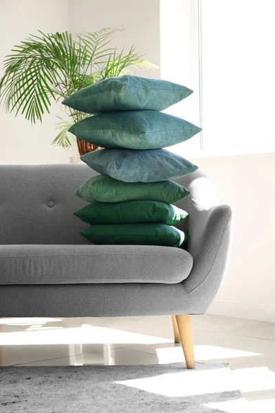 現代のリビングルームでグレーのソファの上にスタイリッシュな枕 — ストック写真