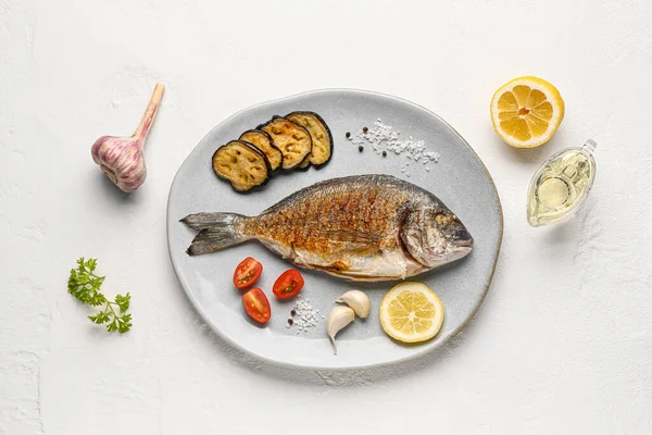 stock image Plate with tasty grilled dorado fish on white background