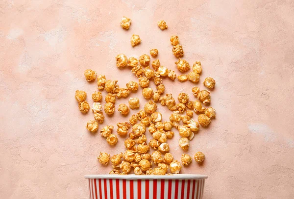 stock image Bucket with tasty popcorn on pink background