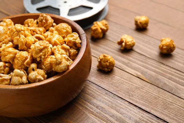 Bowl Tasty Popcorn Film Reel Wooden Background — Stock Photo, Image