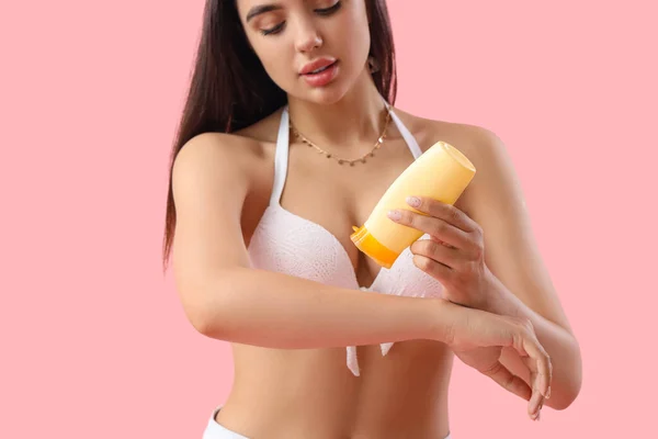 Young Woman Applying Sunscreen Cream Pink Background Closeup — Stock Photo, Image